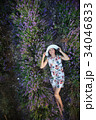 Romantic slender woman lies on lavender field 34046833