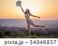 Smiling woman posing on one leg on lavender sunset 34046837