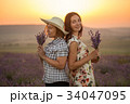 Two women with lavender bunches on the sunset 34047095
