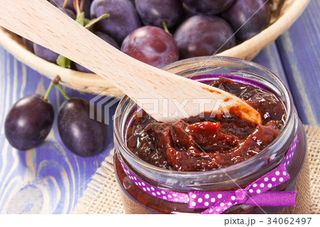 Wooden knife and plum marmalade or jam in jar 34062497