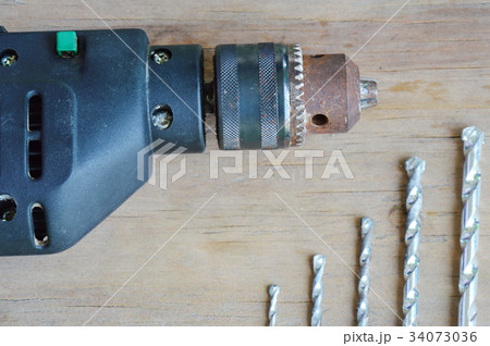 electric drill and different bit on wooden board electric drill and different bit on wooden board 34073036