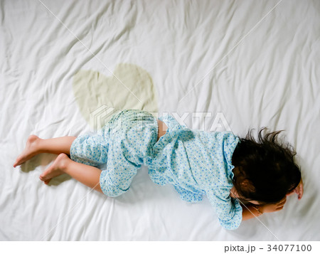 Child pee on a mattress, Little girl feet and pee Child pee on a mattress, Little girl feet and pee 34077100