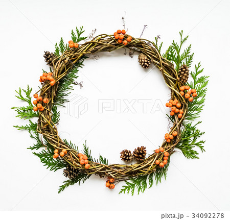 Festive wreath with thuja, berries, cone. Flat lay Festive wreath with thuja, berries, cone. Flat lay 34092278