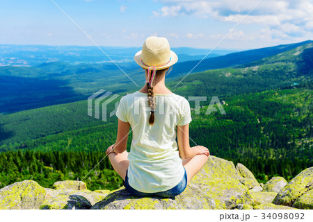 Young travel girl sitting on the rock mountain, relaxing Young travel girl sitting on the rock mountain, relaxing 34098092