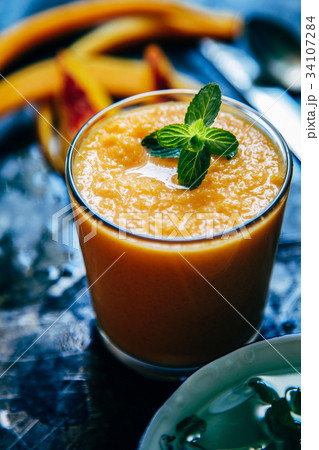 Orange smoothie with leaves of fresh mint 34107284
