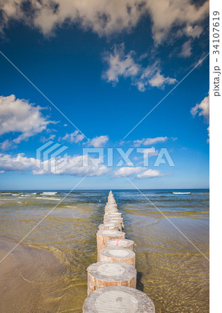 Wooden breakwaters on sandy Leba beach  34107619