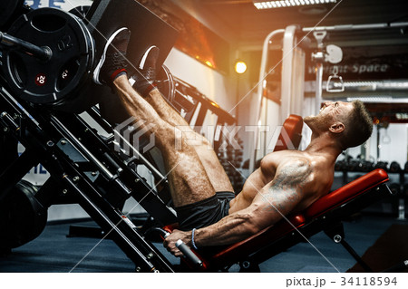 Man Using A Press Machine In A Fitness Club 34118594