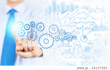 Businessman activating gears mechanism 34137565