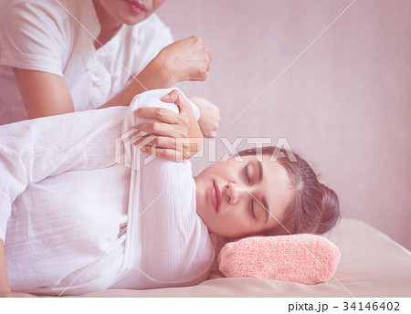Women getting arm stretch in Thai massage course Women getting arm stretch in Thai massage course 34146402