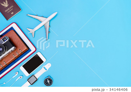 Travel gadgets and objects on blue copy space 34146406