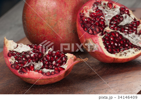 Pomegranate on a timber board Pomegranate on a timber board 34146409