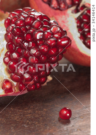 Pomegranate on a timber board 34146414