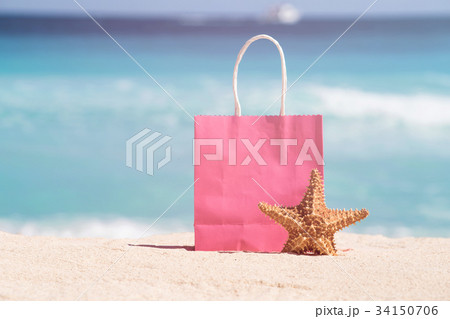 Shopping bag and starfish on sand 34150706