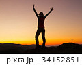 Silhouette of happy young attractive woman jumping 34152851