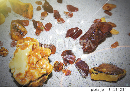 Amber. the pieces of amber in the sand on the Amber. the pieces of amber in the sand on the 34154254
