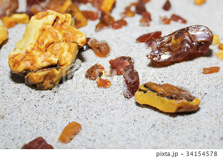 Amber. the pieces of amber in the sand on the Amber. the pieces of amber in the sand on the 34154578