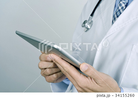 doctor man using a tablet computer 34155260