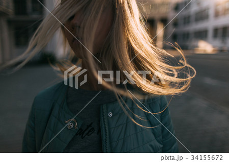 Girl portrait with windy hair in motion closeup 34155672