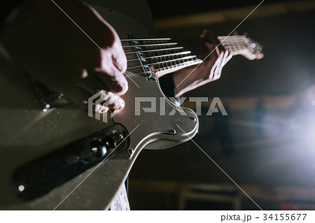 Playing electric guitar in studio closeup 34155677
