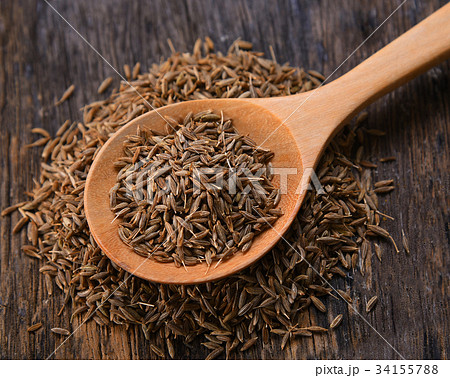 Cumin seeds in spoon wood on table background 34155788