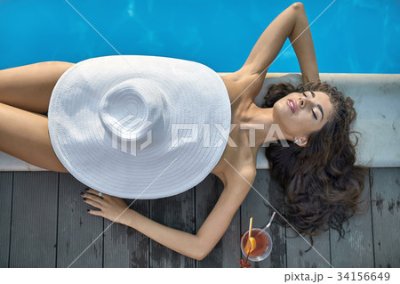 Model near swimming pool outdoors Model near swimming pool outdoors 34156649