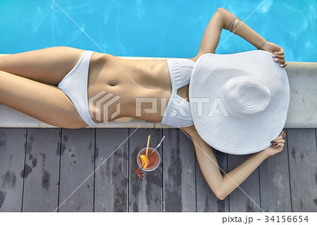 Model near swimming pool outdoors Model near swimming pool outdoors 34156654