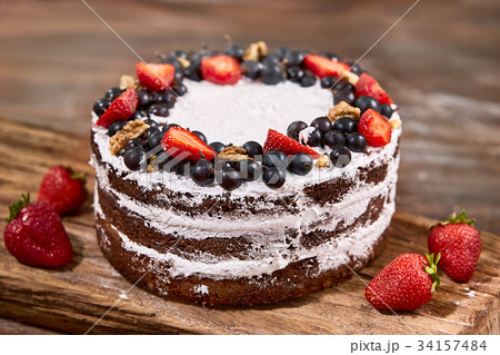 a cut of cake with whipped cream and strawberry 34157484