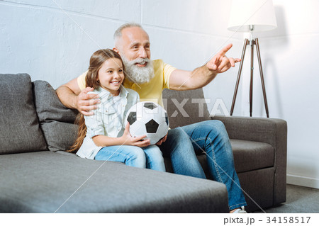 Grandfather and his granddaughter watching Grandfather and his granddaughter watching 34158517