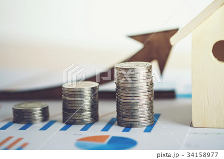 financial banking stock spreadsheet with stack of coin, house an 34158977