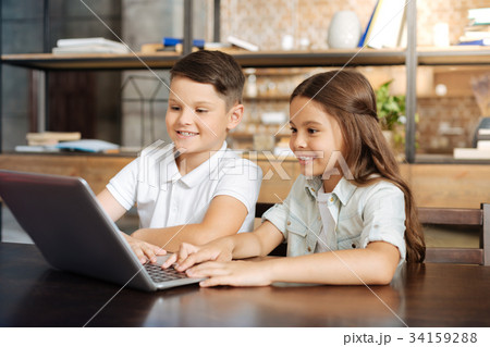 Little brother and sister surfing the web together 34159288