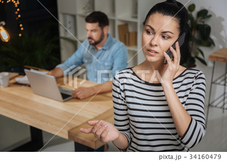 Pleasant nice woman making a call Pleasant nice woman making a call 34160479