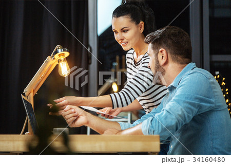 Joyful beautiful woman pointing to the screen Joyful beautiful woman pointing to the screen 34160480