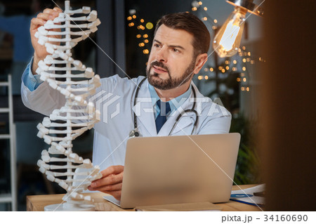 Serious intelligent researcher studying genetics Serious intelligent researcher studying genetics 34160690