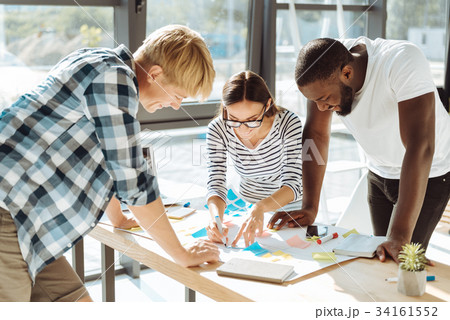 Cheerful young group of people standing in the Cheerful young group of people standing in the 34161552