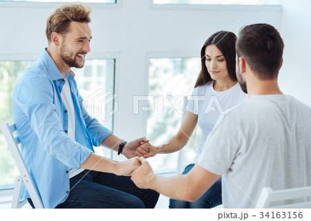 Nice young people holding hands together 34163156