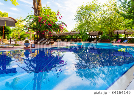 Beautiful blue swimming pool and chair Beautiful blue swimming pool and chair 34164149