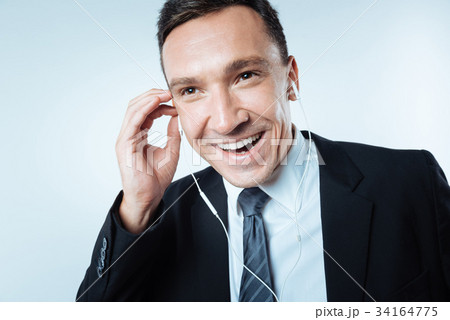 Happy cheerful man enjoying his music Happy cheerful man enjoying his music 34164775