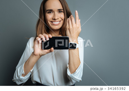 Happy cheerful woman showing her gadgets 34165392