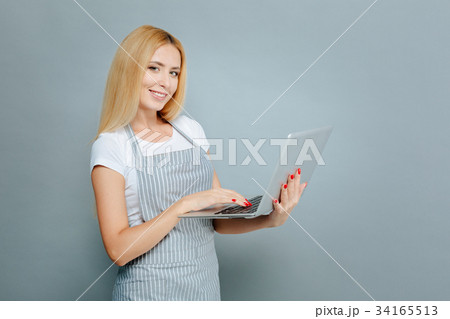 Positive delighted blonde holding laptop Positive delighted blonde holding laptop 34165513