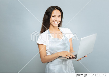 Pretty brunette working with computer 34165935