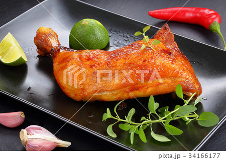 roasted chicken leg quarter on plate 34166177