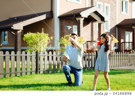 Charming daughter launching paper planes with Charming daughter launching paper planes with 34166898
