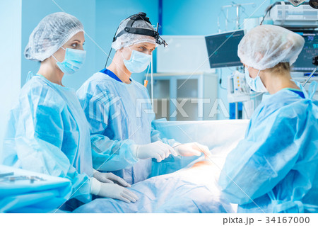 Serious male person standing near his colleagues 34167000