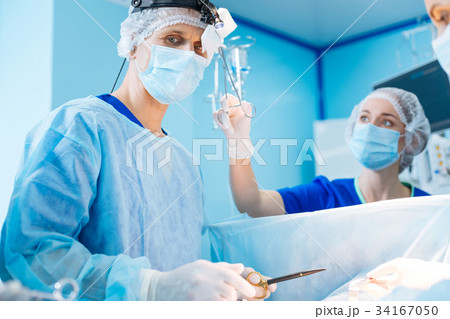 Professional nurse wiping forehead of her boss 34167050