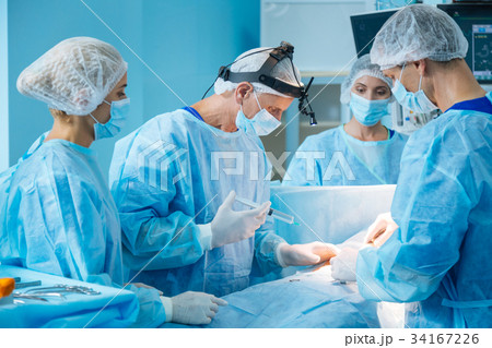 Serious doctor preparing patient for operation 34167226