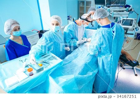 Group of professional medical workers treating 34167251