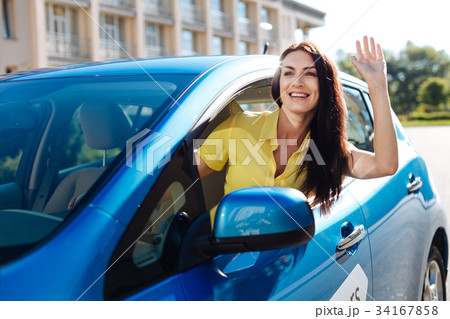 Joyful positive woman greeting her friend 34167858