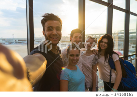 Young People Group In Airport Lounge Near Windows 34168165