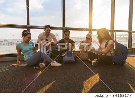 Young People Group Sitting On Floor Airport Lounge 34168177