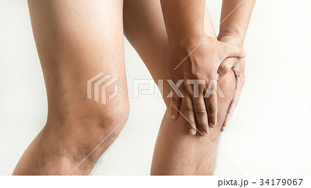the knee man holds on suffering from pain in knee  34179067